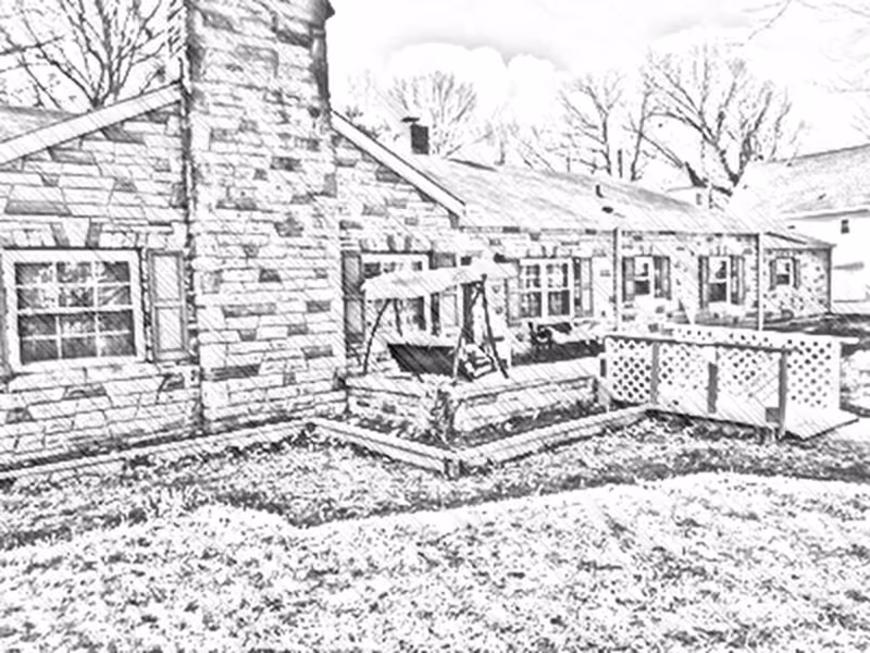 Black and white sketch-style image of the exterior of a single-story stone building with multiple windows, a chimney, a porch swing, and a fenced patio area. Leafless trees are visible in the background.