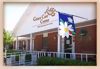 Grace Care Center front entrance with ramp, sign, and decorative banner.