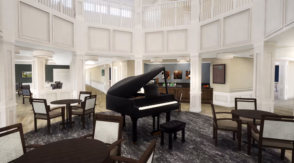 Spacious two-story lounge with a black grand piano in the center, surrounded by round tables and chairs and a reception area in the background.