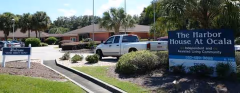 Front view of Harbor House of Ocala facility with signs, vehicles, and landscaping.
