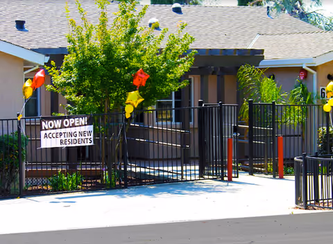 Front entrance of Shearwater Senior Living with a gated walkway and balloons