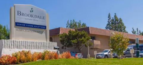 Brookdale Garden Grove senior living exterior with sign and parked cars.