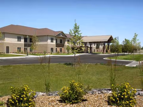 Exterior view of The Grandview at Benefis with a covered entrance and landscaped grounds.