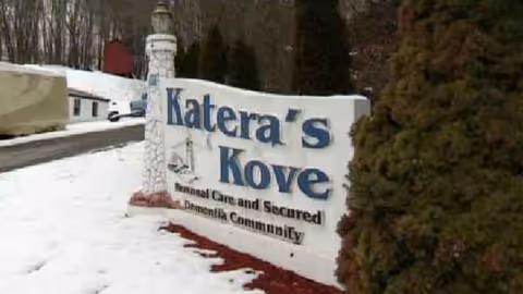 Snowy exterior sign for Katera's Kove at a senior living community
