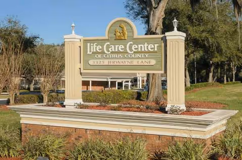Entrance sign for Life Care Center of Citrus County with columns and landscaping.