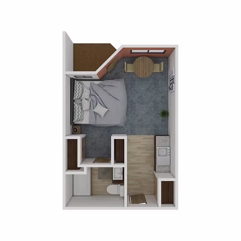 Top-down view of a senior living studio apartment floor plan featuring a bedroom area with a bed and pillows, a small dining area with a round table and two chairs, a kitchenette with a sink, and a bathroom with a toilet and shower. There is also a small closet and an entryway.