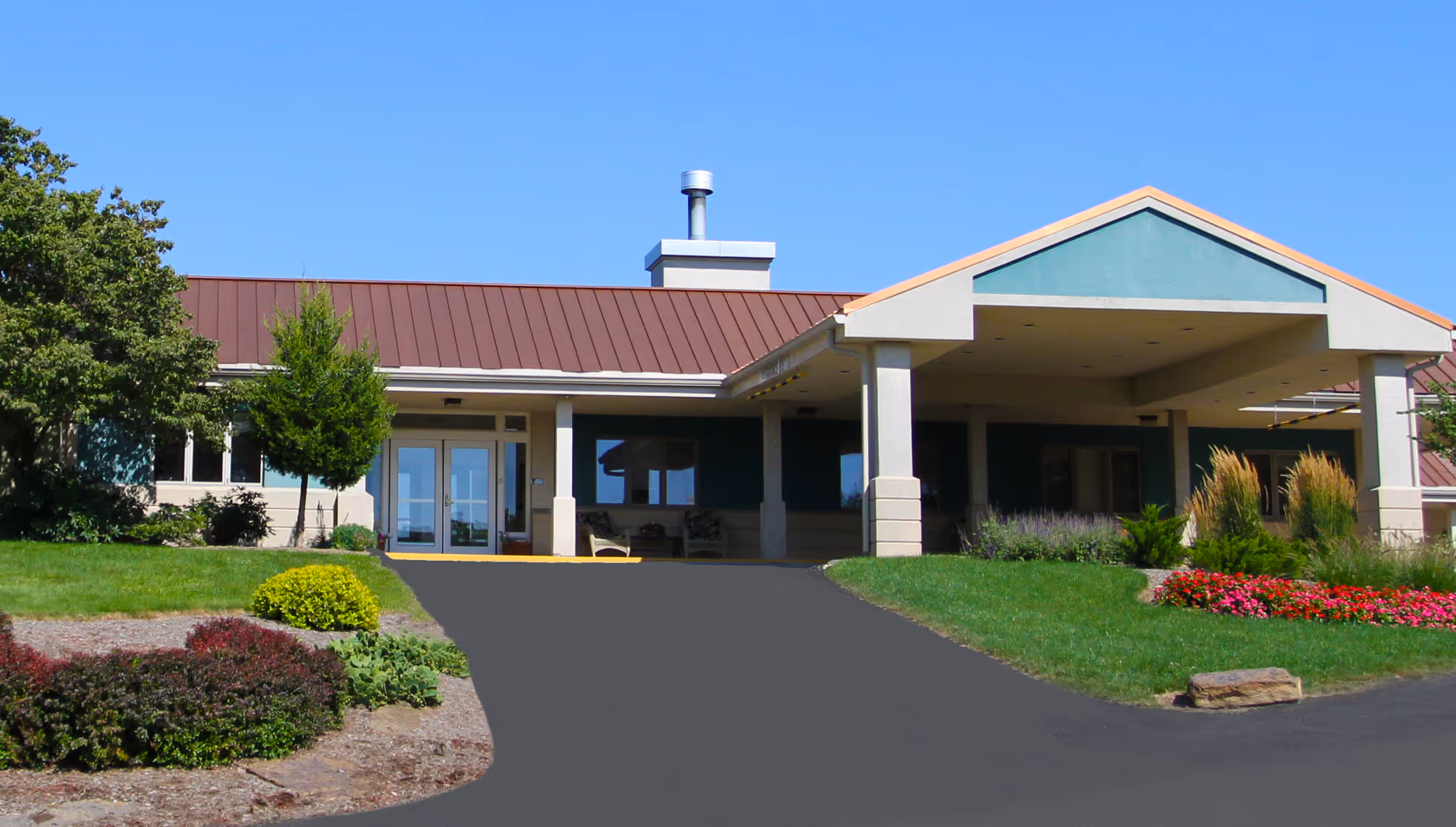 Exterior view of Overlook Green senior living facility entrance with a driveway.