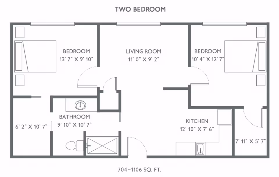 Floor plan of a two-bedroom apartment at Traditions of Columbus showing two bedrooms, a living room, a kitchen, a bathroom, and additional closet/storage spaces with dimensions labeled for each room.