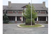 Front view of Summit Place West building with circular driveway and landscaped island.