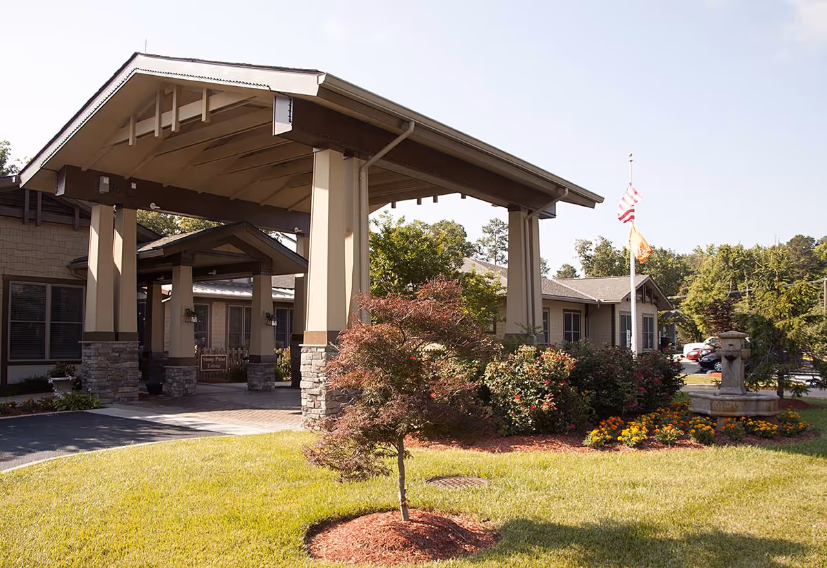 Exterior view of the Sunrise at Bon Air senior living facility showcasing its entrance and landscaped surroundings.