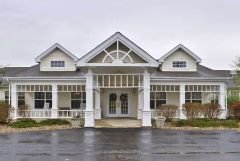 Front view of Orchard Park Assisted Living building with white pillars and covered entry.