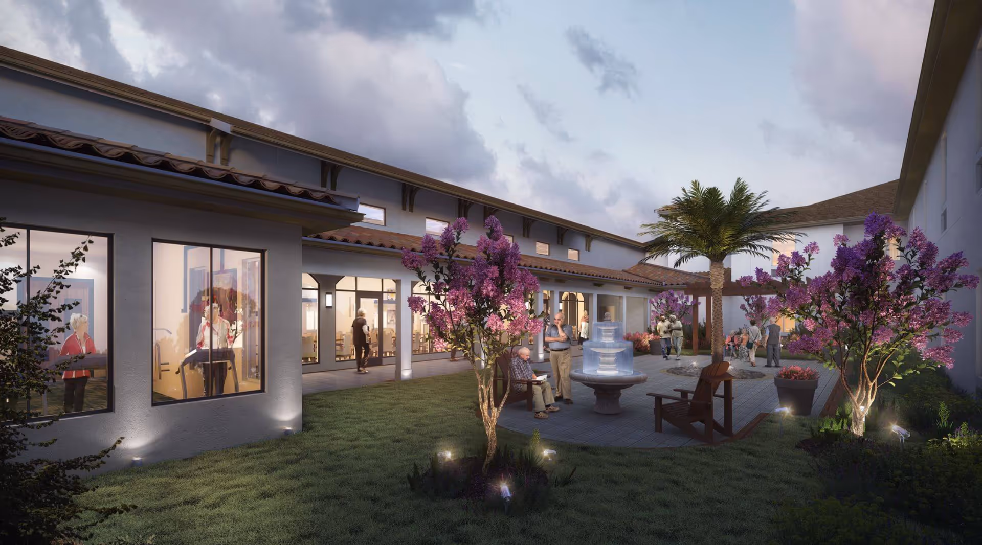 Outdoor courtyard area at HearthStone at Wildwood featuring a paved patio with a water fountain, wooden chairs, palm tree, and flowering bushes. Several elderly people are seen socializing and walking around the courtyard. The building surrounds the courtyard with large windows showing indoor activity rooms.