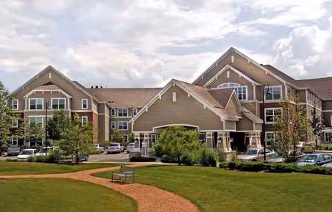 Exterior view of Chestnut Square at the Glen, a senior living campus with parked cars.