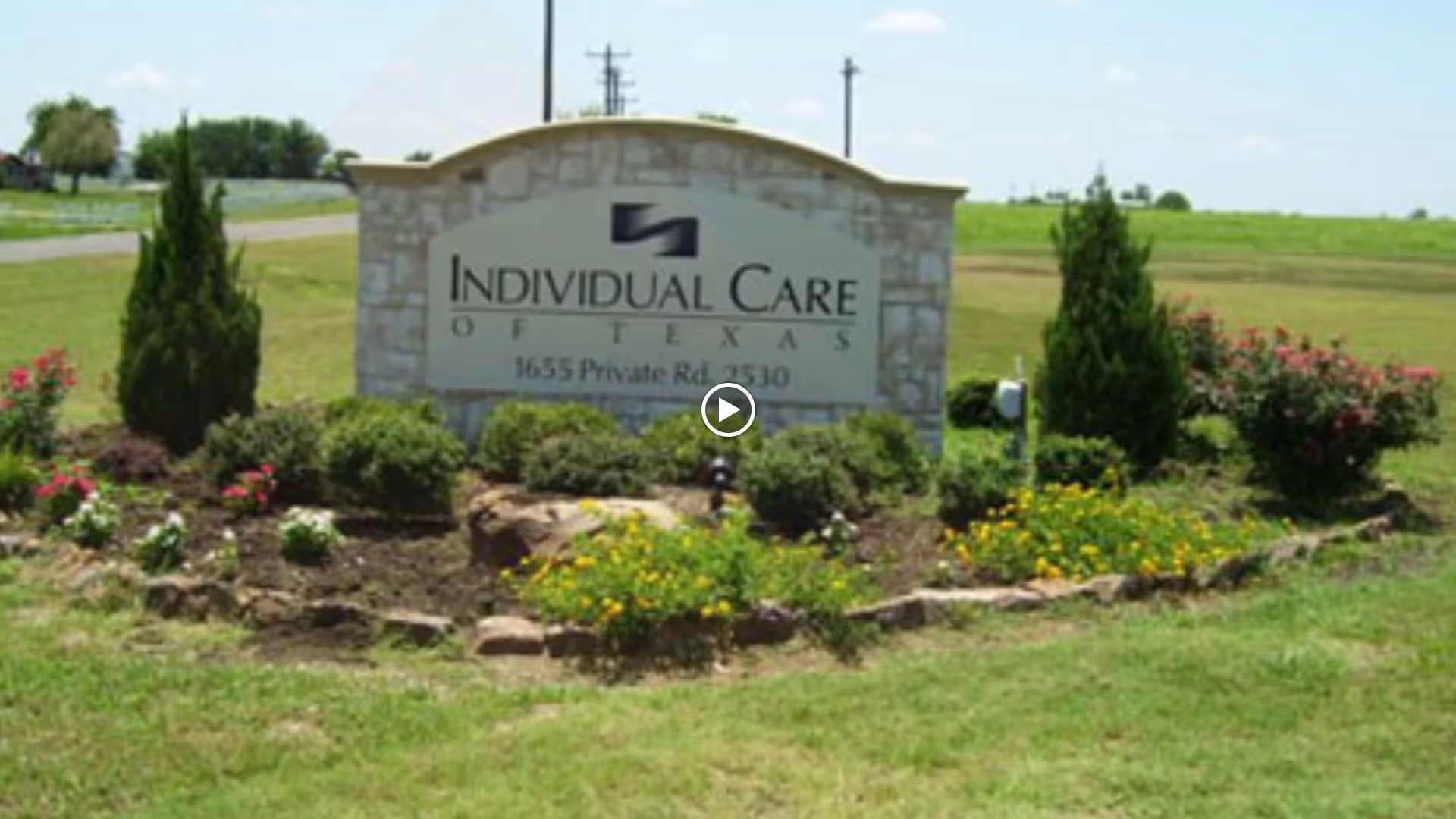 Sign for Individual Care of Texas Inc surrounded by landscaped gardens.