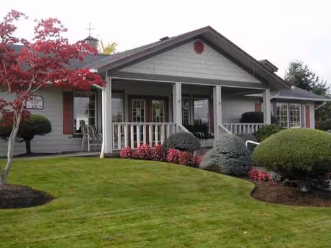 Stillwaters Estates: a single-story senior living facility with a front porch and landscaped grounds.
