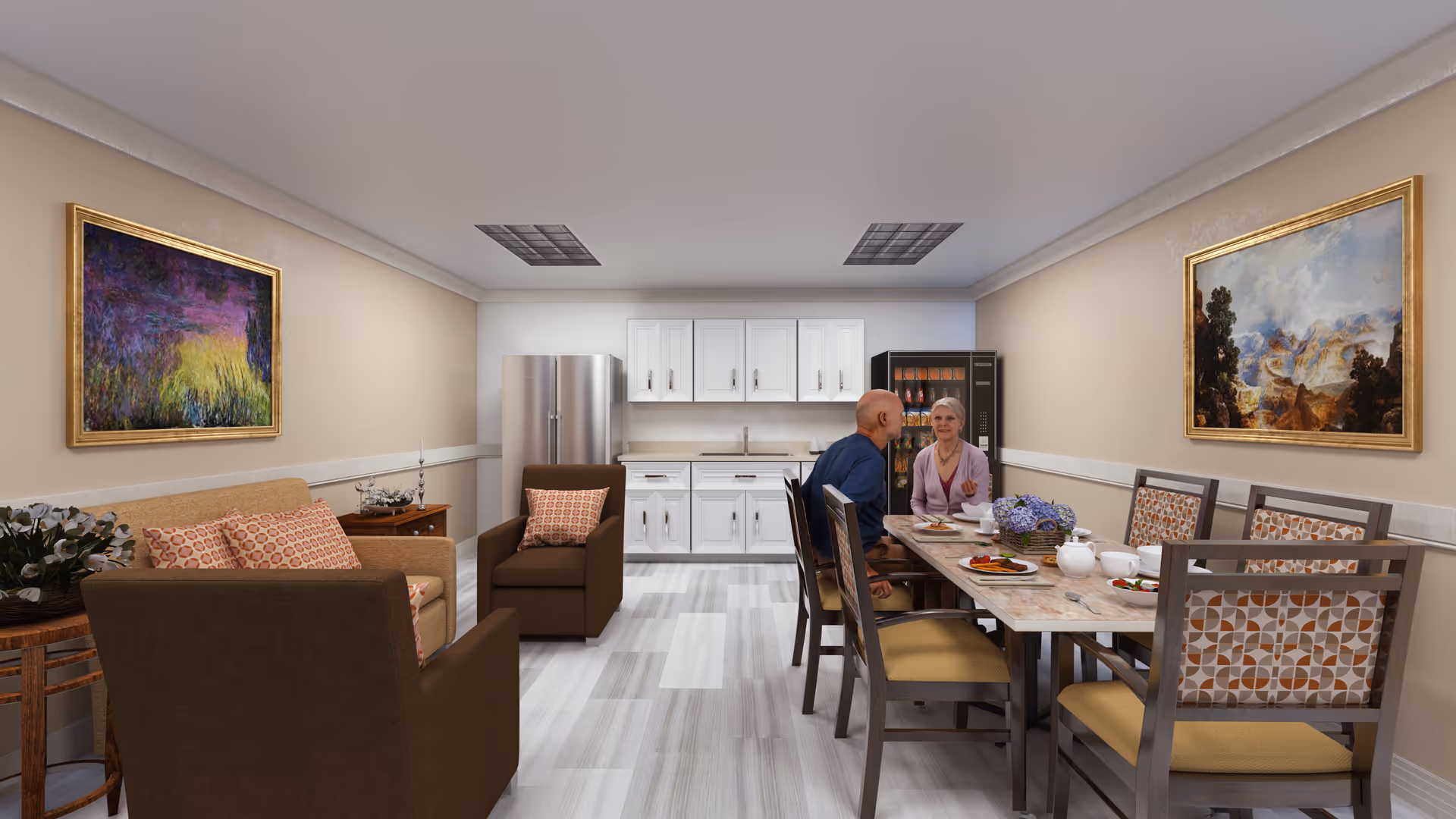 A senior living facility common area with a small kitchen in the background featuring white cabinets, a refrigerator, and a vending machine. In the foreground, there is a dining table with six chairs, two seniors sitting and conversing while having a meal. The room also includes a seating area with a sofa and armchairs, and two framed paintings on the walls.
