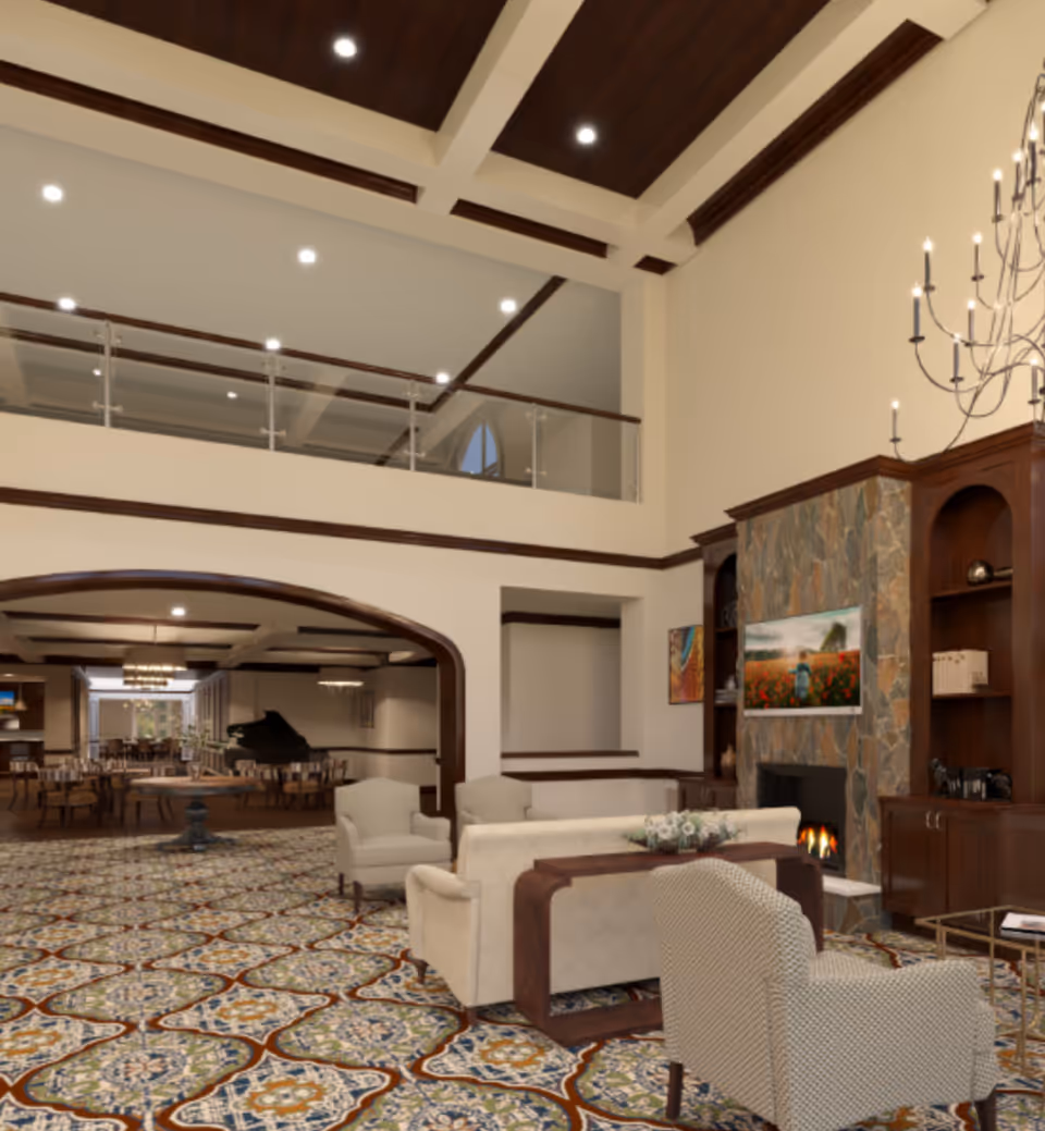 Spacious senior living facility common area with high ceilings, patterned carpet, comfortable seating including armchairs and sofas, a stone fireplace with a mounted TV above it, wooden built-in shelves, and a chandelier. In the background, there is a dining area with tables and chairs and a grand piano.