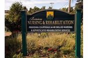 Outdoor blue sign for Avamere Rehabilitation of Burien with landscaping.