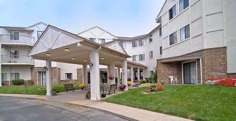 The Cambridge Senior Living exterior shows a covered entrance, manicured lawn, and benches.