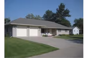 Single-story building with three garage doors and a curved driveway, green lawn in front.