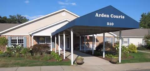 Front exterior of Arden Courts West Orange with blue entrance canopy.
