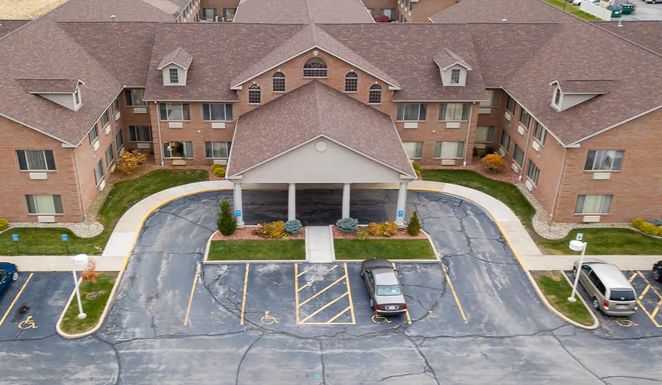 Aerial view of Brentwood at LaPorte exterior building with parking lot and entrance.
