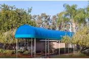 Exterior view of Springwood Center shows a blue curved canopy over the entrance.