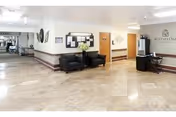This is a spacious Whitney Oaks Care Center lobby with seating area and a reception desk.