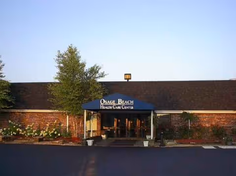 Front entrance of Osage Beach Rehab & Health Care Center with a blue canopy.