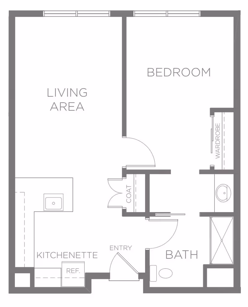 Floor plan of a senior living unit at Sagewood at Daybreak showing a living area, bedroom with wardrobe, kitchenette with refrigerator, coat closet, entry, and bathroom with shower and toilet.