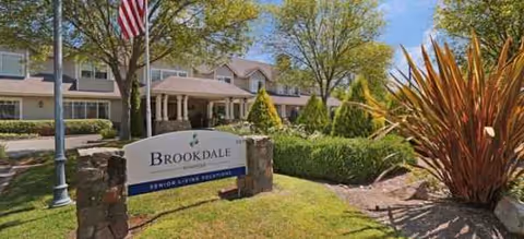 Brookdale Windsor exterior with a stone sign and manicured landscaping