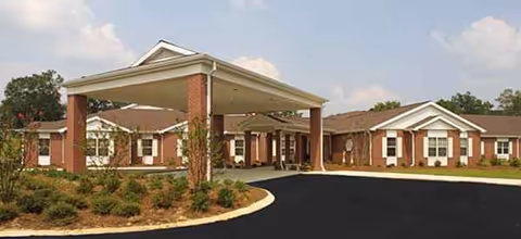Woodlands Rehabilitation and Healthcare Center exterior with a covered driveway and landscaped entrance.