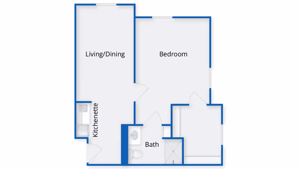 Floor plan of a senior living unit at Benchmark Senior Living at Waltham Crossings showing a living/dining area with a kitchenette, a bedroom, and a bathroom with a shower and toilet.