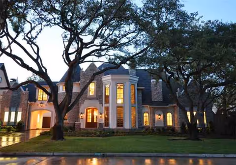 Evening exterior view of Afton Oaks Healthcare and Rehabilitation Center with trees