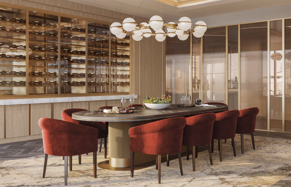 Modern dining room with an oval table surrounded by red upholstered chairs, a central chandelier, and a glass-enclosed wine display wall.