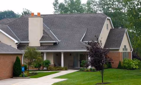 Front exterior view of The Laurels of Massillon with entrance and green lawn.