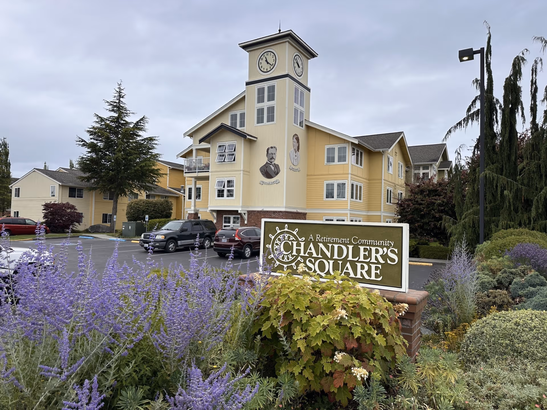 Exterior view of Chandlers Square Retirement Community building with sign and landscaping.