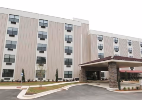 Exterior view of McClellan Senior Living building with a covered entrance.