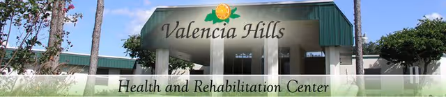 Front entrance of Valencia Hills Health and Rehabilitation Center with a green awning and columns displaying the facility name.