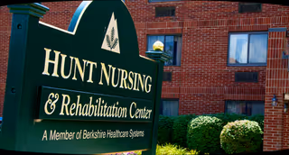 The Hunt Nursing and Rehabilitation Center sign in front of a brick building.