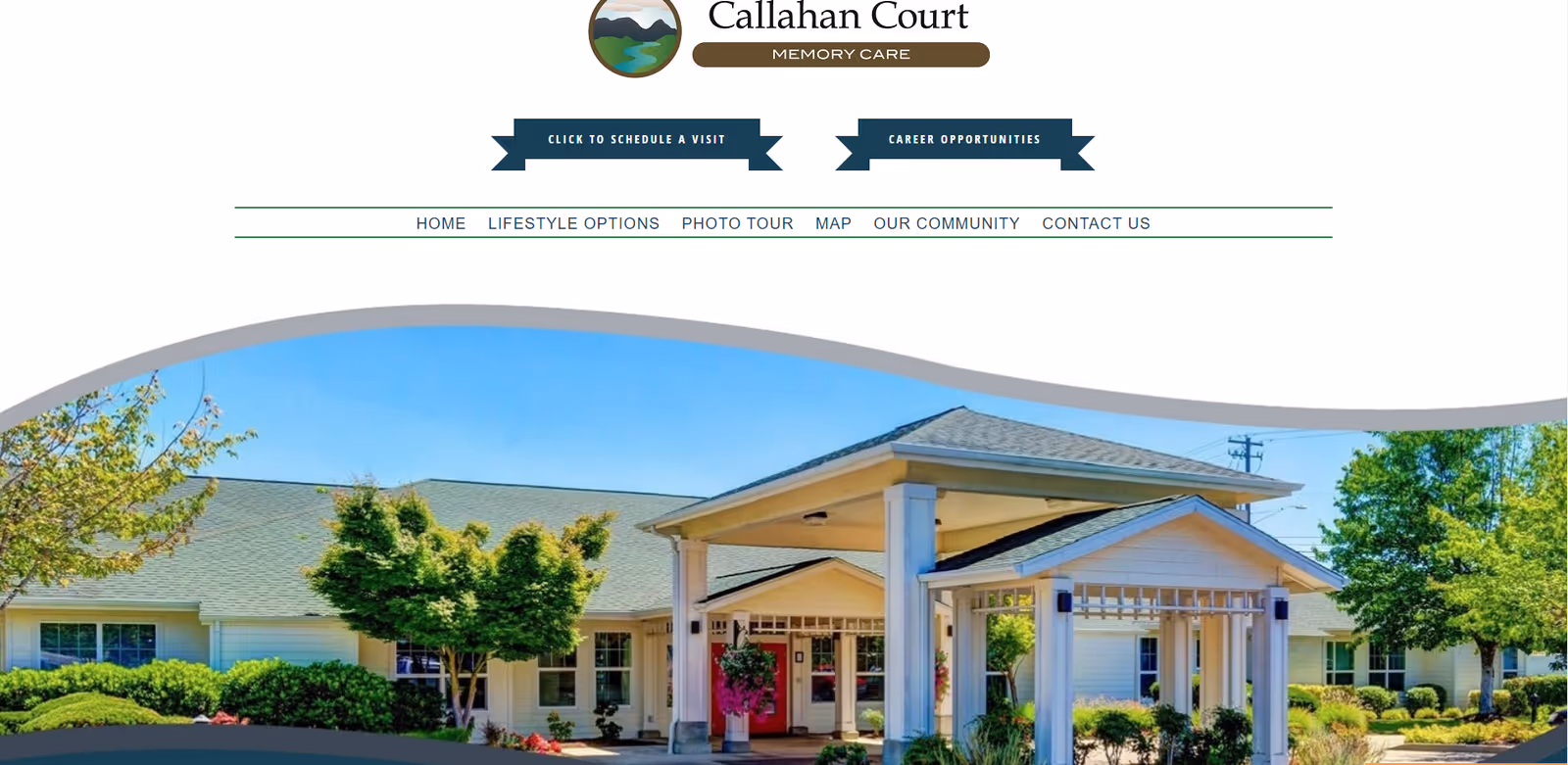 Exterior view of Callahan Court Memory Care building with a covered entrance and landscaped surroundings.