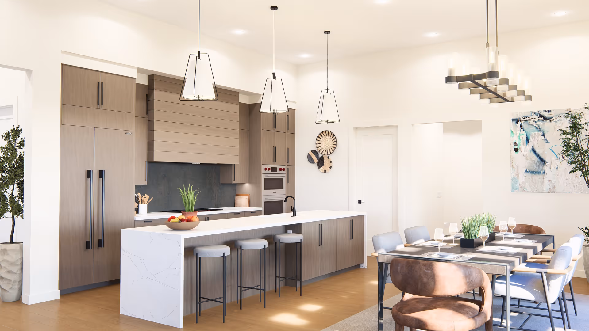 Bright modern kitchen and dining area with wooden cabinets, a large white marble island with three stools, pendant lights hanging above, and a dining table set with chairs, glassware, and a centerpiece plant. There are decorative wall hangings and plants in the room.