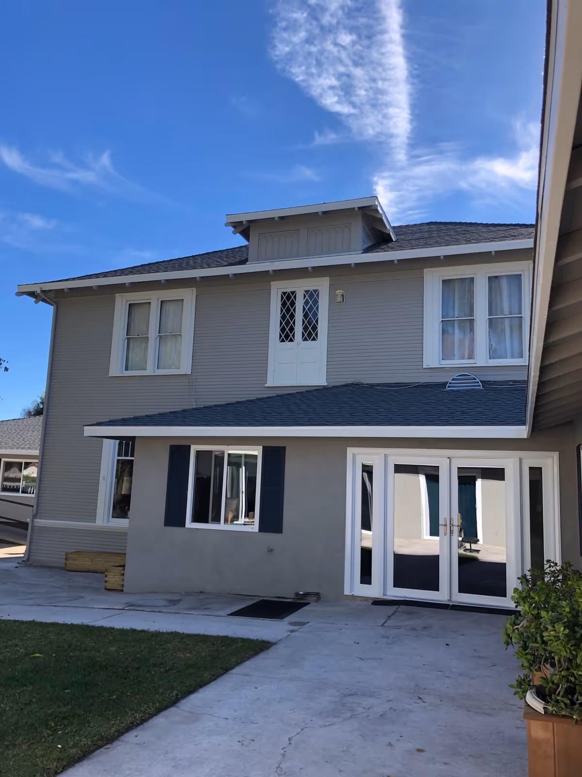 Exterior view of a two-story building at Ventura Grand Chateau with a clear blue sky.