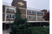 Exterior view of Silver Lake Specialized Care Center building with greenery in front.