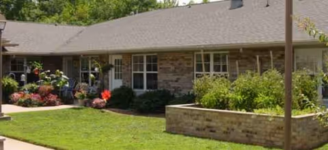 Exterior of Brookdale Eden senior living facility with lawn and planters.