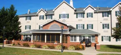 Paramount Senior Living Newark building front with brick entry and landscaped lawn.