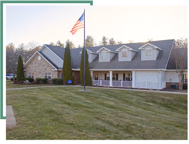 Front exterior view of Fletcher Rehabilitation and Healthcare Center with flagpole and manicured lawn.