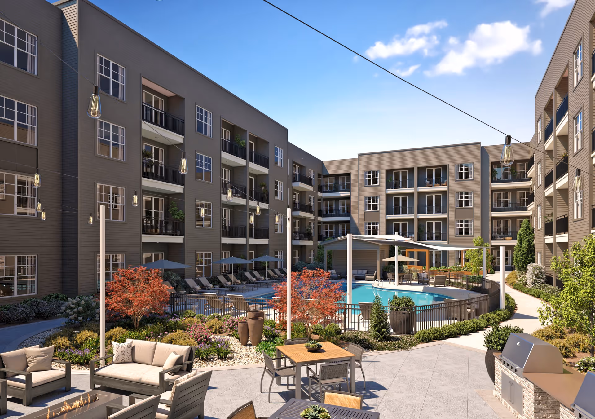 Outdoor courtyard area of Everleigh Duluth featuring a swimming pool surrounded by lounge chairs and umbrellas, patio seating with tables and chairs, a fire pit with cushioned seating, string lights overhead, and a built-in barbecue grill. The courtyard is enclosed by a multi-story residential building with balconies and large windows under a clear blue sky.