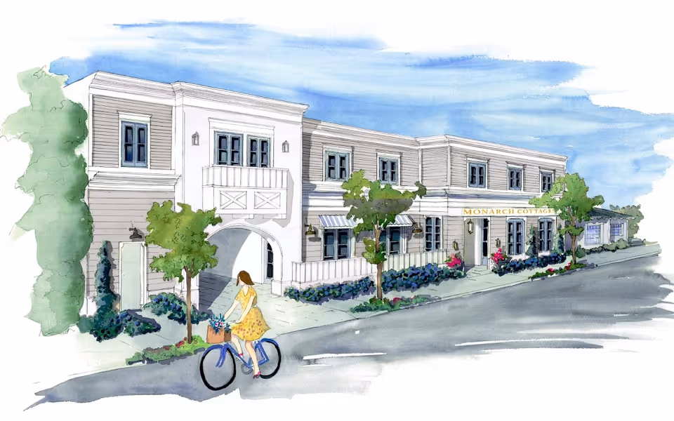 Watercolor illustration of a two-story building named Monarch Cottages with a woman riding a bicycle in front. The building features multiple windows, a small balcony, trees, and landscaped bushes along the sidewalk.