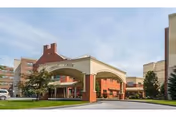 Exterior view of Spring Creek senior living facility entrance with brick arches and landscaping.